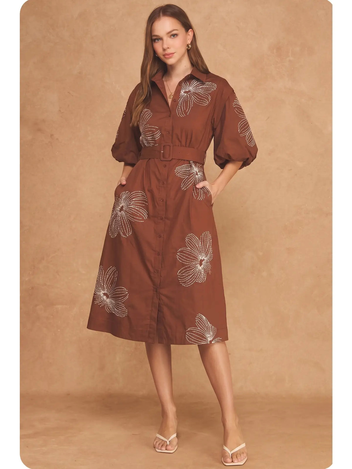 Strut & Bolt brown midi shirt dress with ecru floral embroidery, puff sleeves, button front, and matching belt.