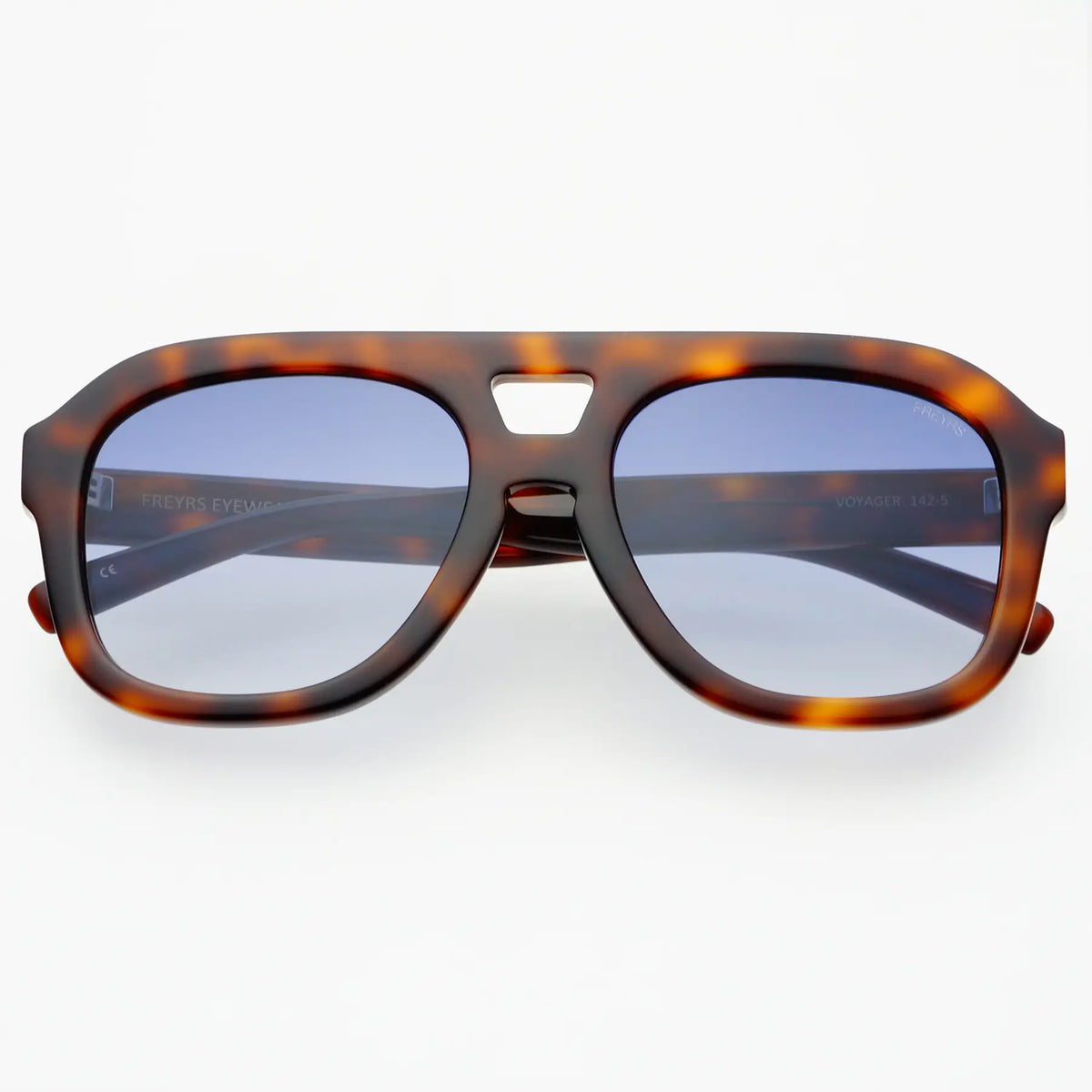 Sunglasses with tortoiseshell frame and blue lenses on a white background